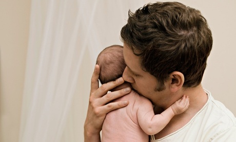 A father holding his new born baby