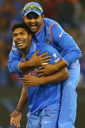 Umesh Yadav is congratulated by Suresh Raina after getting the wicket of Mushfiqur Rahim.