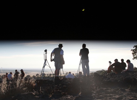 People observe the solar eclipse Sunday, May 20, 2012 in Chico, Calif.  The annular eclipse, in which the moon passes in front of the sun leaving only a golden ring around its edges, was visible to wide areas across China, Japan and elsewhere in the region before moving across the Pacific to be seen in parts of the western United States. (AP Photo/The Chico Enterprise-Record, Jason Halley)