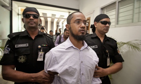 Members of Bangladesh’s Rapid Action Battalion force escort Farabi Shafiur Rahman.