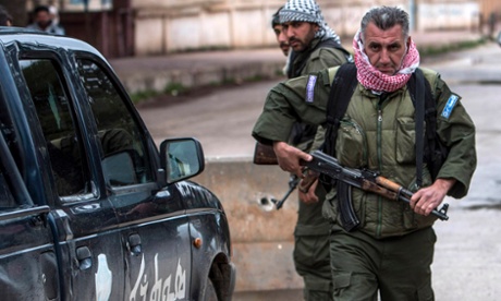 Christian fighters of Sutoro (The Syriac Security Office) guard a checkpoint in the town of Tel Tamr.