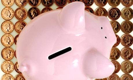 A piggy bank on some coins