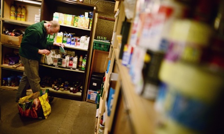 A volunteer packs food at a food bank