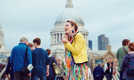A woman dressed in bright colourful clothes stands out in the crowd in front of St Pauls