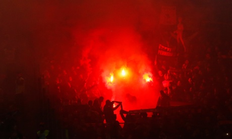 AS Roma's supporters light flares before the match.