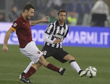 Francesco Totti is closely watched by Juventus' Claudio Marchisio.
