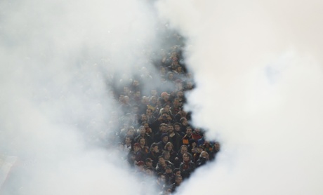Smoke of flares engulfs Roma's fans before the match.