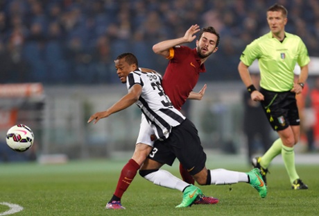 Patrice Evra is looking lively but he is halted here by AS Roma's Miralem Pjanic.