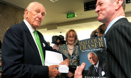 This file photo taken on  March 4, 2010 shows former Australian prime minister Malcolm Fraser (L) signing a copy of his first political memoirs at the University of Melbourne's Law School.