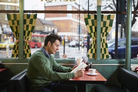 man reading in cafe