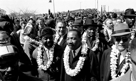 Martin Luther King leads the march across the Edmund Pettus Bridge in Selma, 21 March 1965