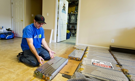 Jason Hughes with one of his Tesla batteries.