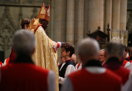 Dr John Sentamu lays hands on Lane during the service at York Minster, where she was consecrated as the eighth bishop of Stockport.