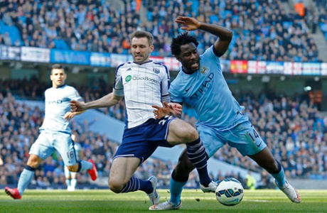 West Bromwich Albion's Gareth McAuley tackles Manchester City's Wilfried Bony ...