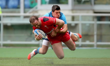 Wales' Jamie Roberts looks pleased to go over the line and score the first try of the game.