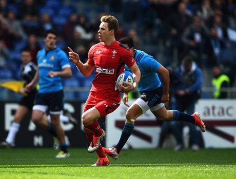 Liam Williams celebrates as he strides towards the try-line ...