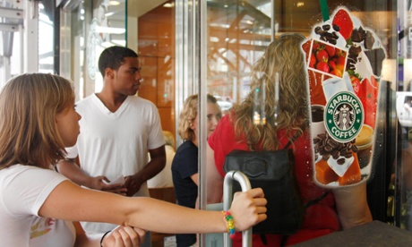 People enter a Starbucks in New York