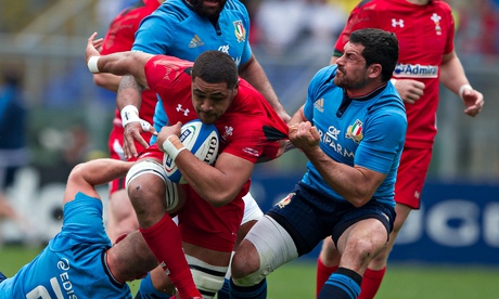 Italy's Andrea Masi tries to haul down Wales's Taulupe Faletau during the Six Nations match