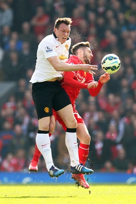 Adam Lallana and Phil Jones collide.