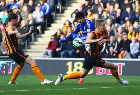 Diego Costa shoots past Michael Dawson of Hull City to score the second.