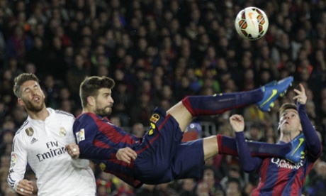 Gerard Piqué almost takes off the head of his Barcelona team-mate Lionel Messi as he beats Real Madrid's Sergio Ramos to the ball.