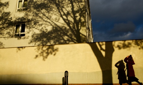 Child's silhouette on a wall near a house. 