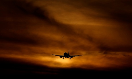 A plane coming in to land at dusk at Heathrow