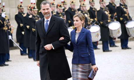 King Felipe VI and Queen Letizia of Spain walk past a guard of honour prior to meeting François Hollande in Paris.