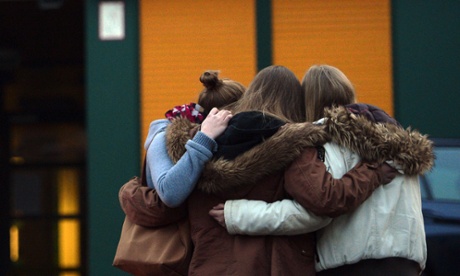 Students gather at a memorial of flowers and candles outside the Joseph-Koenig-Gymnasium school in Haltern.