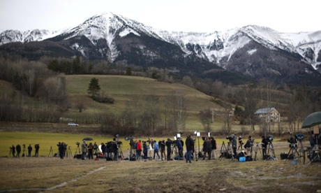 Reporters and television crews gather near the scene of the crash