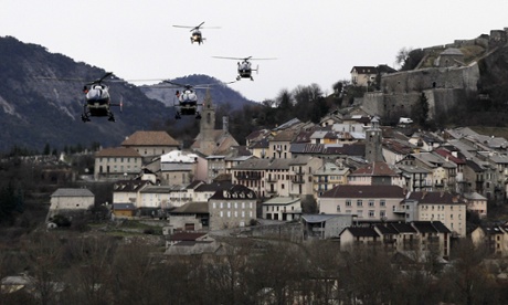 Helicopters of the French gendarmerie and emergency services fly over Seyne-les-Alpes.