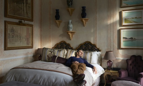 Rupert lying on a bed in his luxury room at the Gritti Palace