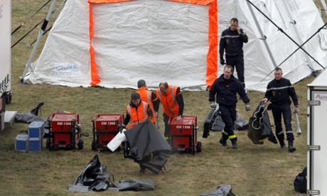 Members of the emergency services prepare tents 