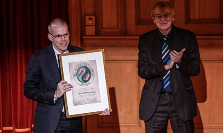Bill McKibben (L) representing the organization 350.org of the U.S. receives the Right Livelihood Award from Jakob von Uexkull during the Right Livelihood Award ceremony at the second chamber hall at the Swedish Parliament in Stockholm December 1, 2014. McKibben receives the award for 