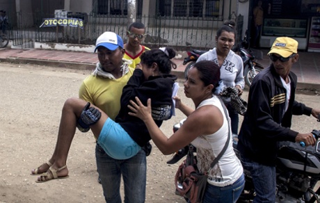 A teenage girl is brought to hospital in Carmen de Bolivar, Colombia, after fainting.