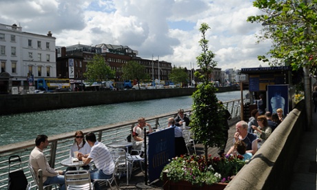 Cafegoers by the River Liffey in Dublin