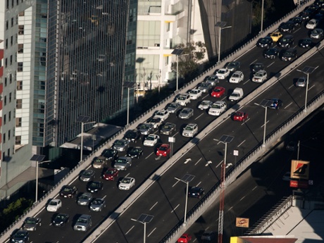 Traffic moves along an upper level of the Periferico highway in this aerial photograph taken from a helicopter in the a fleet of helicopters operated by the Federal District Secretariat of Public Security, in Mexico City, Mexico.