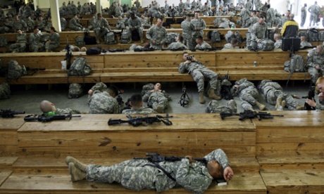 A soldier reads while resting at Fort Bragg