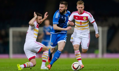 Scotland's Russell Martin and Matt Ritchie in action with Northern Ireland's Stuart Dallas.