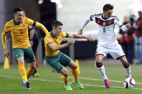 Austarlia's Jason Davidson and Matthew McKay chase Mesut Ozil.