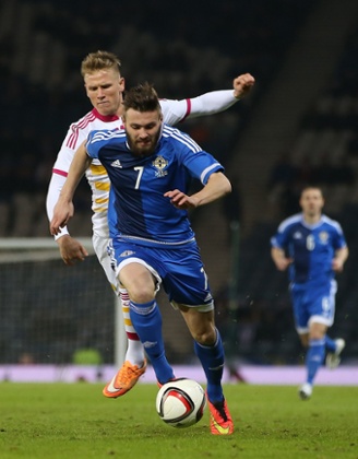 Stuart Dallas runs with the ball.