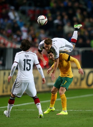 Shkodran Mustafi is upended as he competes for the ball with Matthew Leckie.