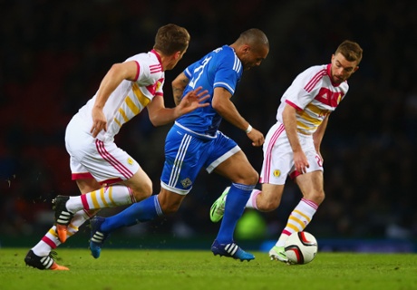 Josh Magennis flies past James Morrison.