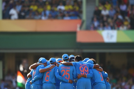 The Indian players huddle after taking the wicket of Glenn Maxwell.