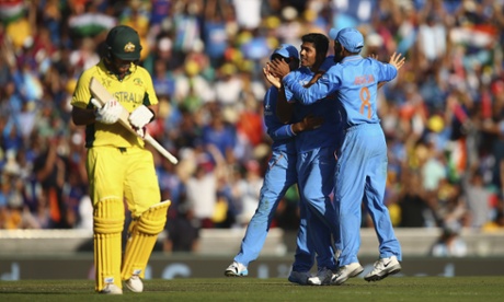 Umesh Yadav of India celebrates taking the wicket of Aaron Finch as the Australian trudges from the pitch.
