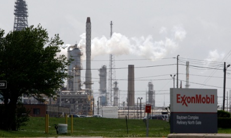steam rises from towers at an Exxon Mobil refinery in Baytown, Texas