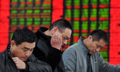 Investors look at share prices at a stock brokerage in Fuyang, east China.