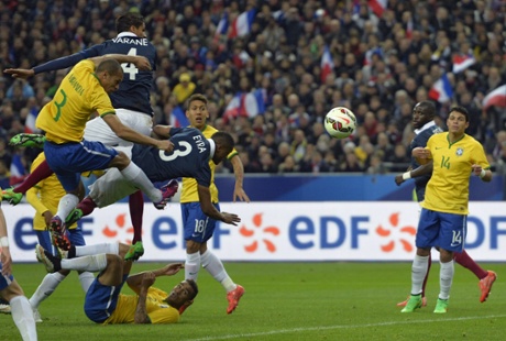 Raphael Varane heads the ball to score.