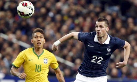 France's Morgan Schneiderlin fights for the ball with Brazil's Firmino.