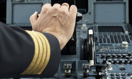 A pilot at the controls of a plane